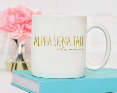 White mug with "Alpha Sigma Tau alumna" written in gold foil