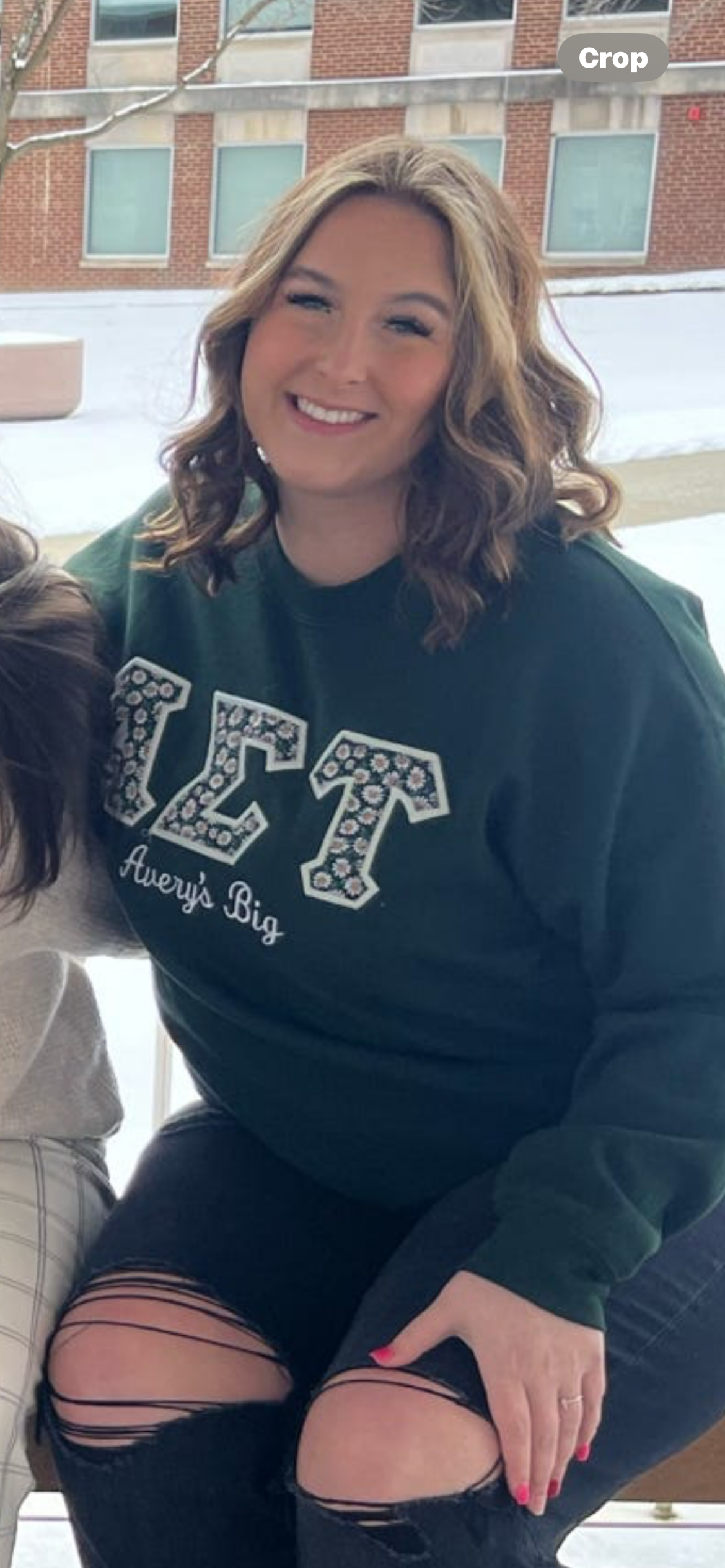 Headshot of Jenni Kemmery in front of book cases displaying Sorority archives.